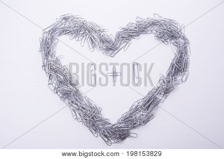 Heart make from paper clips on the white background