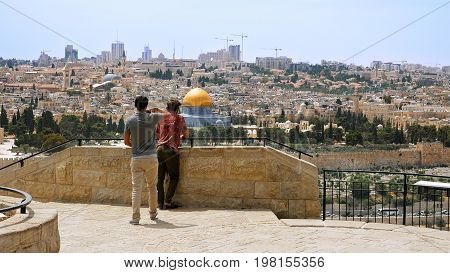 Jerusalem, Israel - May 25, 2017: Tourist takes a photo and selfie against Jerusalem Old City view. Mount of Olives is a famous Holy Land place and it has a fantastic view to the Old Jerusalem