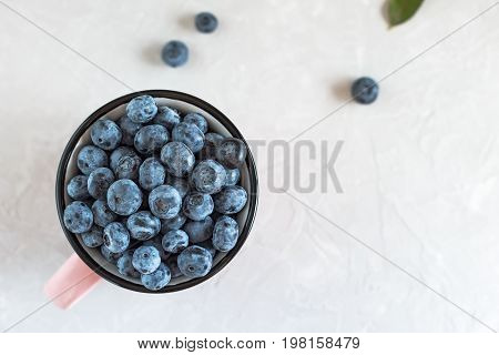 Organic Blueberries In A Mug For Healthy Eating On Light Gray Table.