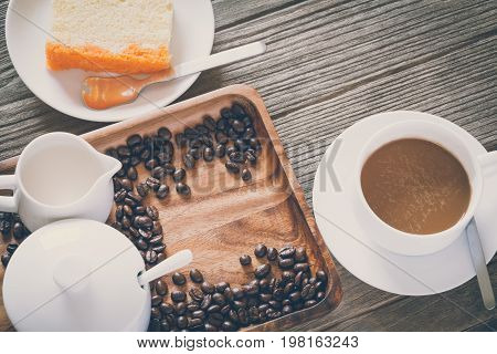 Vintage Film Look: cup of coffee with cake on wooden boards abstract background