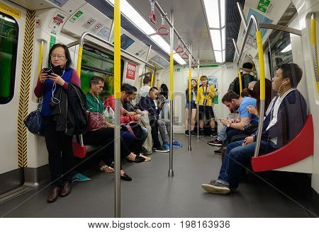 People Sitting On Subway Train In Hong Kong