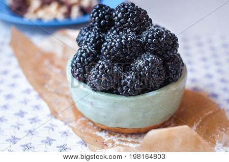 Homemade, sweet, delicious blackberries in a handmade dish