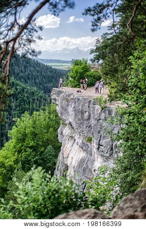 TOMASOVSKY VYHLAD SLOVAKIA - JUN 3: Tourists sitting on the rock at viewpoint in Slovak paradise on Jun 3 2017 in Tomasovsky vyhlad