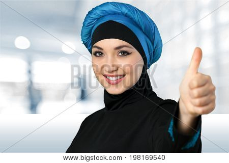 Woman thumb muslim looking at camera make up yellow white