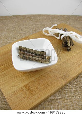 Fresh liquorice sticks on a wooden board