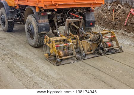 Truck Compacting Gravel At Road Construction Site