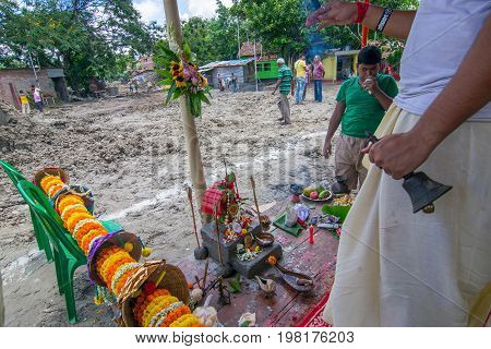 HOWRAH WEST BANGALINDIA - JULY 7TH 2017 : khutipuja the starting ritual of world famous Durga Puja (most famous festival of Hinduism) is being performed by a Hindu Priest amongst Hindu devotees.