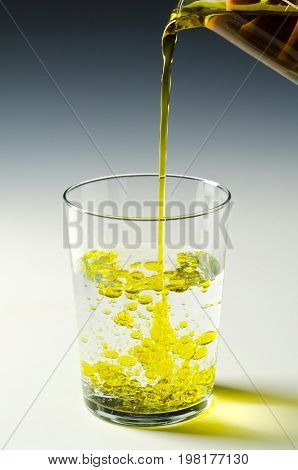 Physics. Immiscible fluids. Oil being poured into water. 1 of 4 image series.