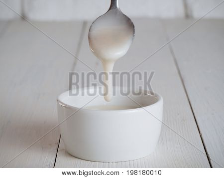 White homemade natural raw organic coconut butter, cream or urbech - healthy raw vegan food. Natural nut paste from coconut. Dagestani useful delicacy
