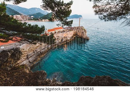Coast venetian fortress Castello in Petrovac, Montenegro. Popular tourist attraction in Petrovac and Adriatic sea by evening.