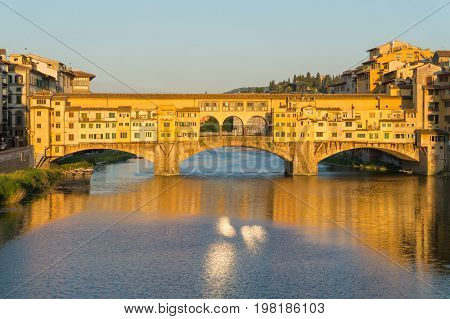 Ponte Vecchio bridge over the Arno River in sunset light, Florence, Italy. The bridge first mention was in a document of 996. One of the main attractions of Florence.