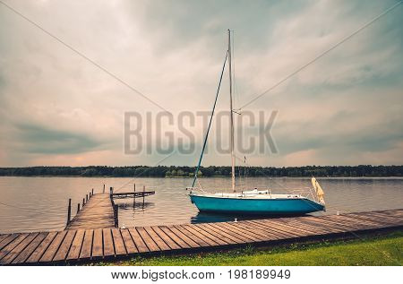 Boat on the water. Wooden pier on the lake.