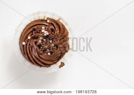 Chocolate capcake on white background top view. Place for text