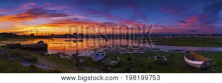 Derelict boats in the backwaters of Holes Bay Poole Harbour at low tide