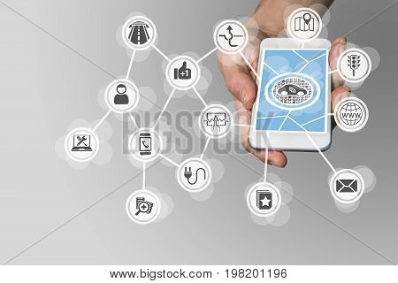 Hand holding smart phone in order to manage connected car components like infotainment system