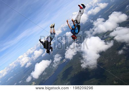 Skydiving over beautiful Norway. Clouds, sun and sky