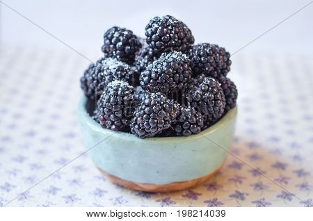 Homemade, sweet, delicious blackberries in a handmade dish