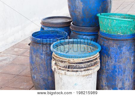 dirty white and blue garbage bin with copyspace on the left