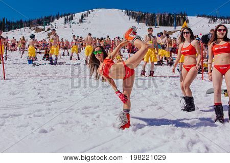 Group Of Young Happy Pretty Women On A Snowboard In Colorful Bikini.