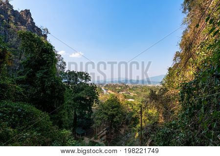 Wide angle picture of amazing view from Tham Chang Cave in the city of Vang Vieng Laos. Tropical Vegetation.