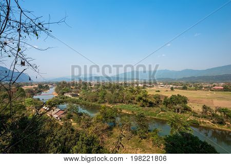 Wide angle picture of amazing view of Nam Song River from Tham Chang Cave in the city of Vang Vieng Laos. Tropical Vegetation.