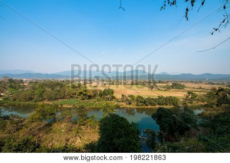 Horizontal picture of amazing view of Nam Song River from Tham Chang Cave in the city of Vang Vieng Laos. Tropical Vegetation.