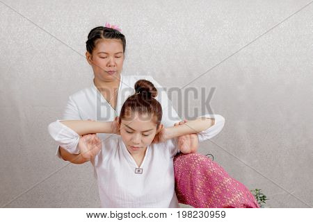 Asian Woman Getting Traditional Thai Stretching Massage By Therapist
