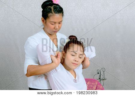 Asian Woman Getting Traditional Thai Stretching Massage By Therapist