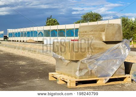 Concrete curbs. Construction of high-speed bypass road around Krasnoe Selo Saint Petersburg. Excavation works at civil industrial construction. Russia