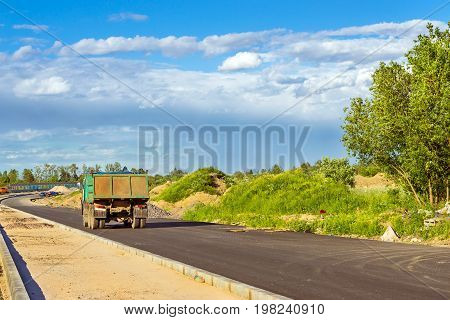 Heavy truck on construction of high-speed bypass road around Krasnoe Selo Saint Petersburg. Heavy machine equipment for civil industrial construction. Russia