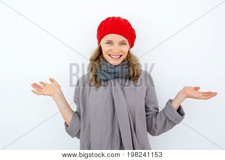 Smiling misunderstanding woman shrugging shoulders and looking at camera. Playful young French woman gesturing as symbol of incomprehension. Unaware concept