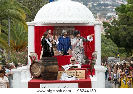 FUNCHAL MADEIRA PORTUGAL - SEPTEMBER 4 2016: Men in historical fashion dress raise toasts durnig historical and ethnographic parade of Madeira Wine Festival in Funchal. Madeira Portugal