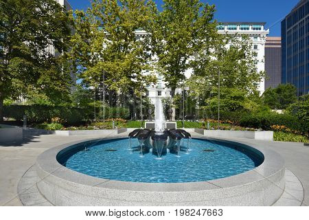 SALT LAKE CITY, UTAH - JUNE 28, 2017: Joseph and Hyrum Smith statues in Temple Square. A fountain is in the foreground of the LDS founders.