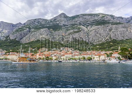 MAKARSKA RIVIERA, CROATIA - 1 JULY, 2017: View of the port of the resort town of Makarska in the summer day.