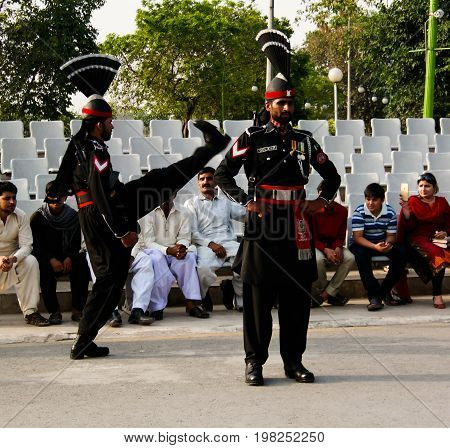 The marching Pakistani guards in national uniform at the ceremony of lowering the flags - 04-05-2015 border between Pakistan and India Wagah Lahore Pakistan
