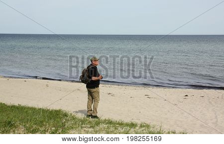 Tourist looking to the Baltic Sea on the island Falster. Denmark