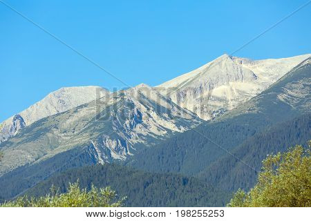 Summer panorama of georgeos Pirin mountains landscape with pine trees and high peaks, Bansko, Bulgaria