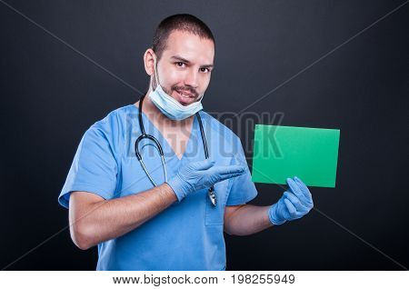 Doctor Holding And Showing Green Copypsace Card