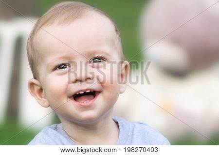 laughing little boy in park at summer day