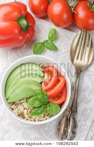 Warm Quinoa Salad With Vegetables - Avocado, Red Onion, Tomatoes, Bell Pepper, Basil And Olive Oil.