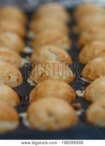 Takoyaki with octopus. The process of making the popular Japanese snacks. Selective focus