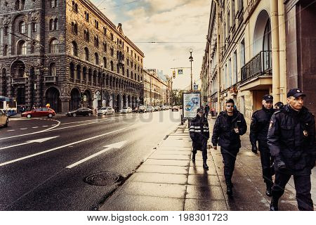 Saint Petersburg, RUSSIA - June 1, 2017: The historical center or downtown of St. Petersburg, houses, architecture, a detachment of policemen is walking along the sidewalk