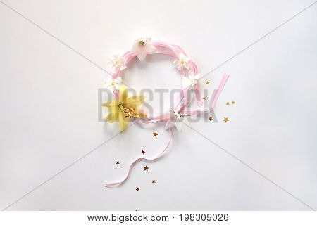 Round frame of pink ribbon with flowers and srars isolated on white background. Women`s day concept.