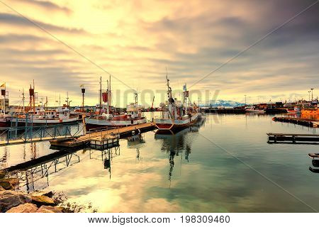 Traditional Fisherman Boats Lying In The Harbor Of Husavik