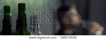 Glass Bottles And Man Drinking