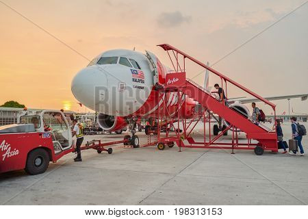 KUALA LUMPUR, MALAYSIA - MAY 02, 2014: people boarding at AirAsia aircraft at the airport. AirAsia is the largest airline in Malaysia by fleet size and destinations