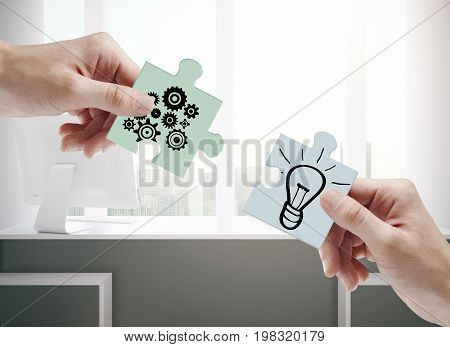 Hands putting puzzle pieces together on office interior background. Teamwork cooperation and idea concept. 3D Rendering
