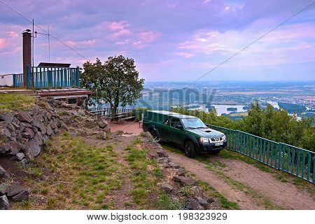 Lovos, Czech Republic - July 05, 2017: Green Jeep Nissan On Top Hill Lovos Next To Tourist Cottage W