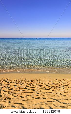 Summer seascape, Apulia coast: Marina di Pulsano beach.It's characterized by a alternation of sandy coves and jagged cliffs overlooking a truly clear and crystalline sea.Lonely boat on the horizon.