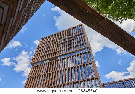 Veiw on new loft style modern building made of brown bricks with big wide windows. Rectangular building architecture. Russian modern loft architecture. Luxury real estate